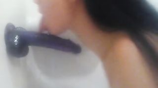 Sucking Purple Dildo In Shower